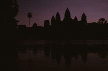 temple ruins in Cambodia at sunset with a purple sky
