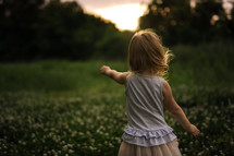 toddler girl outdoors in a field 