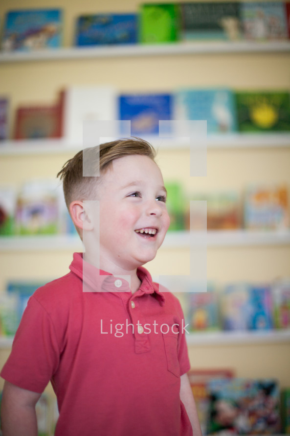 a smiling little boy looking up 
