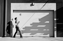 man tip toeing in front of a garage