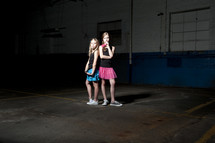 girls posing in an empty warehouse