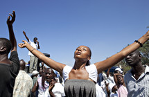 A woman with arms raised in worship