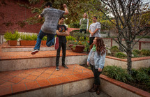 Teens standing around outdoors. 