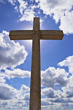 wooden cross in front of a blue sky 