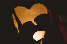 silhouette of a couple kissing 