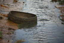 old tire in a small stream