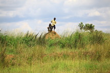 African boys on dirt mound