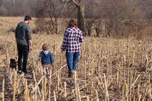 a family walking outdoors in a field 