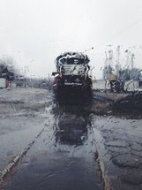 rain on a window and view of parked trains