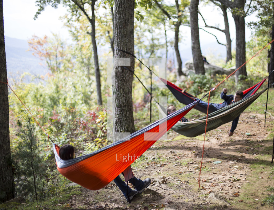 hammocks tided to trees in a forest 