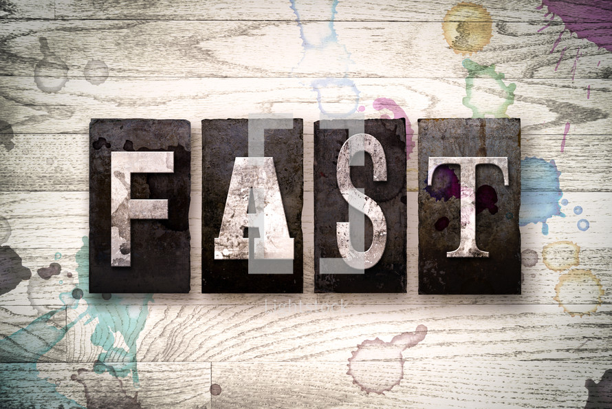 word fast on wood background 