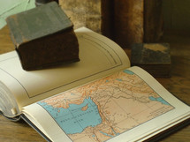 Old books and an old Bible with a map of Israel,.