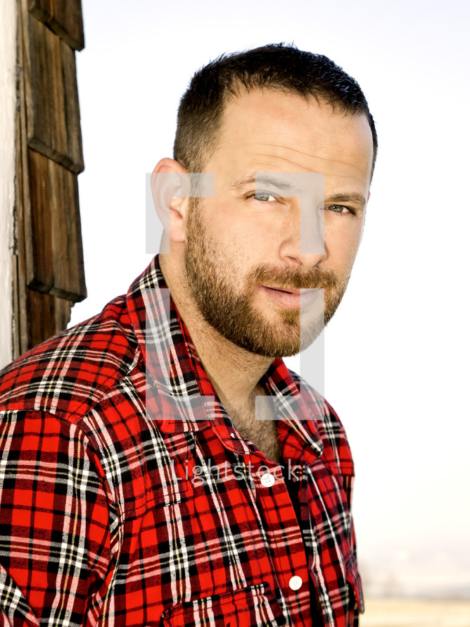 headshot of a man in a flannel shirt 