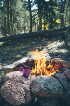 coffee mug and flames in a campfire 