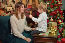 A Boy with Cochlear Implants ringing a Christmas bell 