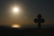 sunburst in the sky and cross silhouette 