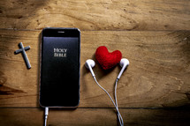 Bible app on a smartphone with earbuds 