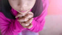 closeup of a little girl praying 