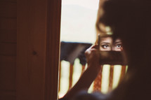 a woman looking into a mirror 