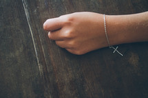 cross bracelet on a wrist 