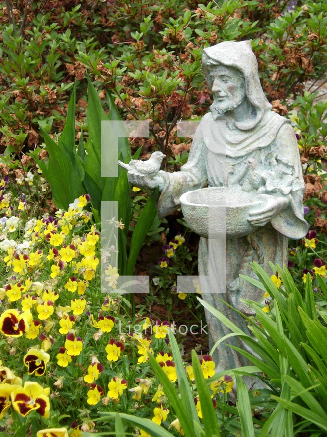Saint Francis, the Patron Saint known to minister to the Animals. Here is a statue of Saint Francis with birds in a garden. 