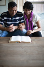 an Indian couple reading a Bible together 