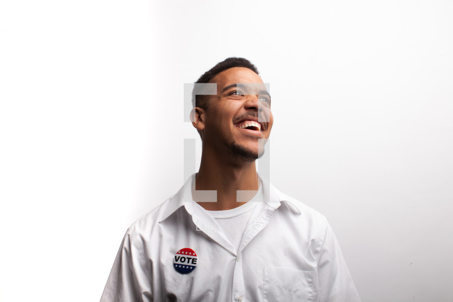 young man wearing a vote button 