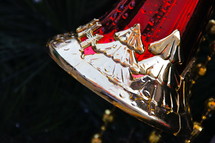 Red and gold Christmas bell with trees on it