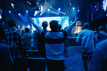 arms raised in praise during a worship service 