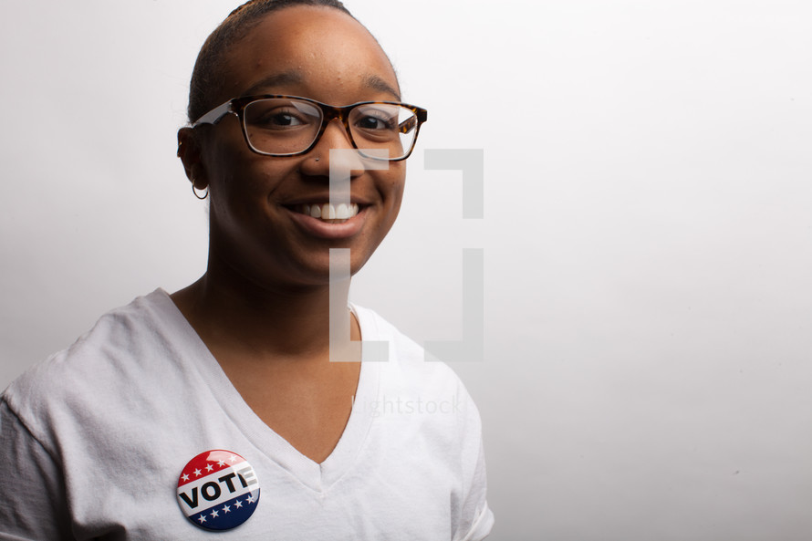 young woman wearing a vote button 