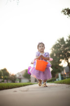 children trick or treating on a neighborhood sidewalk on Halloween 