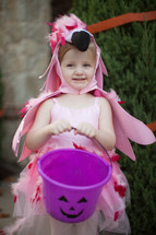 a little girl in a flamingo halloween costume 