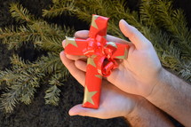 cross wrapped in paper as a present at Christmas day. 
presents, present, cross, Christmas, birth, death, born, die, dying, give, given, gave, son, advent, save, savior, saving, redeem, redeeming, redeemer, Christmas day, tree, fir, branch, twig, gift, star, stars, red, golden, wrap, wrapped, wrapping, wrap, packaging, packing, packed, pack, Xmas, fancy paper, gift wrap, wrapping paper, hand, offer, provide, offering, providing, hands