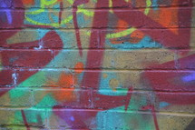 Graffiti on a brick wall. 
graffiti, wall, mural, brick, bricks, art, spray, spraying, youth, rebel, color, colors, colorfully, colorful, multicolored, paint, painting, sign, signs, urban, street art, message, messages, social, culture, genre, artistic, marker pen, expression, expressions, background, young, teens, cool