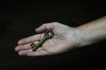 rusty key in a hand 