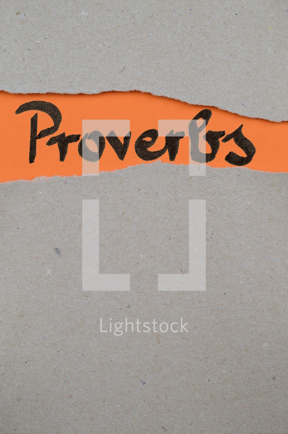 Proverbs - torn open kraft paper over orange paper with the name of the book Proverbs 