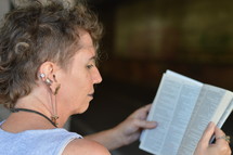 a woman battling addiction reading a Bible 