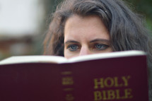 eyes of a woman reading a Bible 
