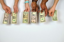 hands donating dollar bills