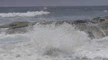Ocean waves crashing on a rocky shore.