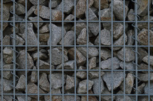 stones behind metal fencing 