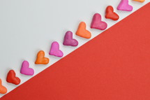 hearts, pink, orange and red on red and white background 