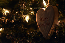 heart shape wooden ornament on a Christmas tree 