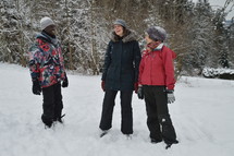 friends standing in snow 