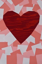 pile of blank rose, antique pink and white notepads showing a part of the red wooden background in the shape of a heart 