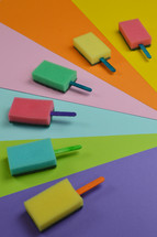 multicolored sponge popsicles on multicolored background as thank you for the volunteer cleaning team in church or as decoration for the vacation bible school in the classroom