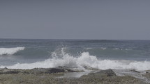 Ocean waves crashing on a rocky shore.