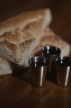 The Lord's Supper with pieces of bread and three goblets of wine 