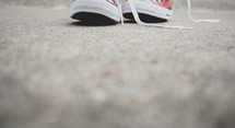 sneakers on a sidewalk 