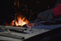 blacksmith working with a red-hot horseshoe.